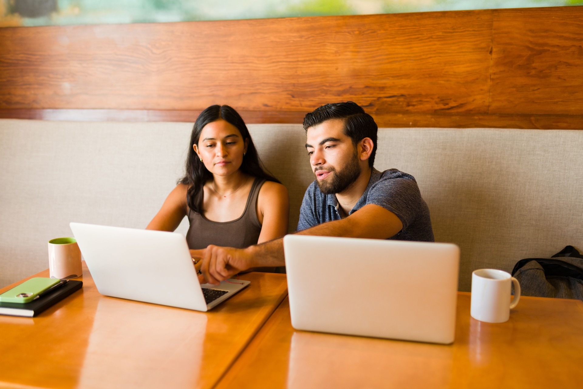 Teamwork doing remote or freelance work together at the cafe